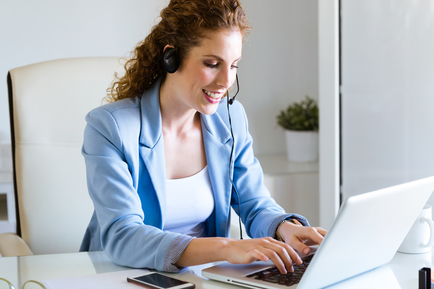 Customer service operator talking on phone in the office. Customer service operator talking on phone in the office.